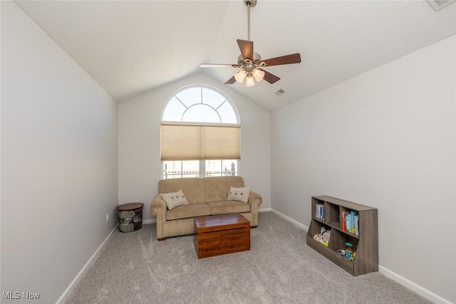 living room featuring lofted ceiling, light colored carpet, and ceiling fan