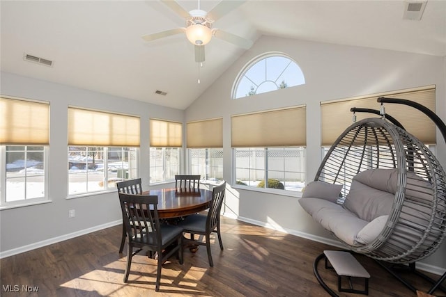 dining space with dark wood-type flooring, ceiling fan, lofted ceiling, and a wealth of natural light