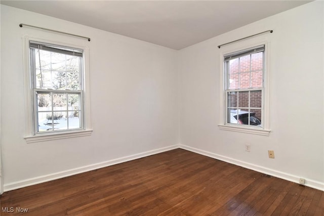 spare room with dark hardwood / wood-style flooring