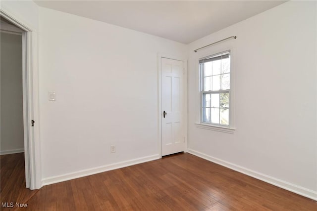 spare room featuring dark hardwood / wood-style flooring