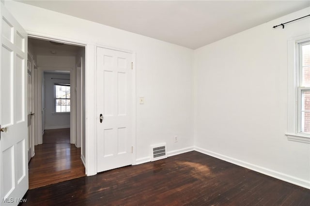 spare room with dark hardwood / wood-style flooring