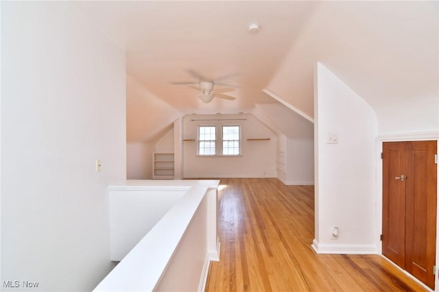 bonus room with ceiling fan, lofted ceiling, and light wood-type flooring