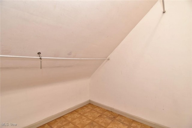 spacious closet featuring lofted ceiling and light parquet flooring