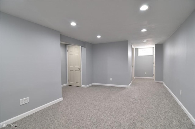 basement featuring light carpet