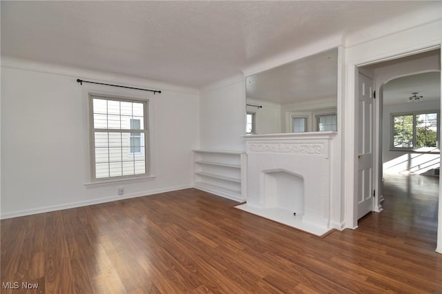 unfurnished living room with dark hardwood / wood-style floors