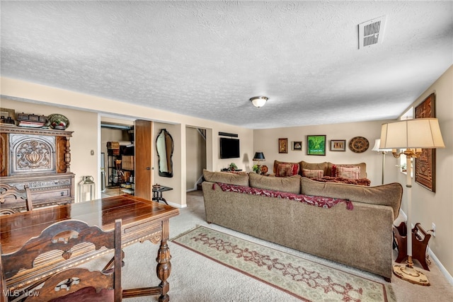 living room with light colored carpet and a textured ceiling