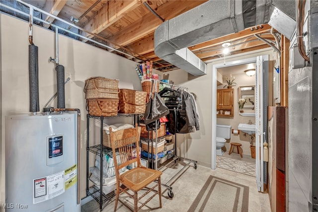 basement with water heater and sink