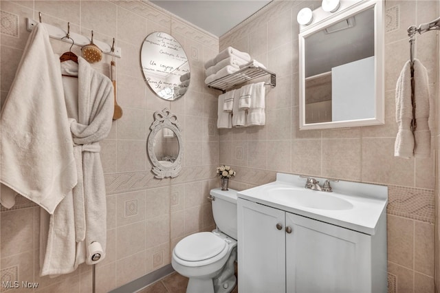 bathroom with tile walls, vanity, and tile patterned floors