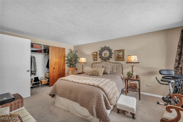 bedroom featuring light colored carpet, a closet, and a textured ceiling