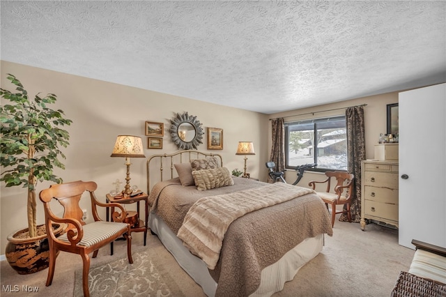 bedroom featuring light carpet and a textured ceiling