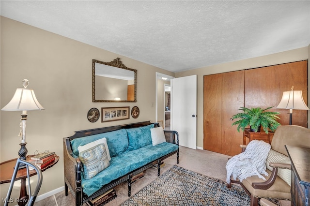 living room with light colored carpet and a textured ceiling