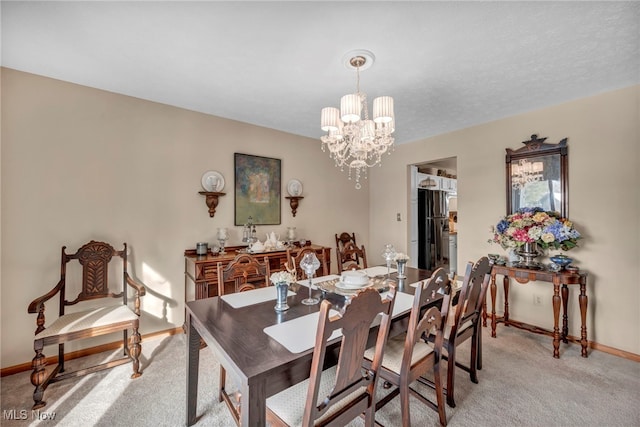 carpeted dining room featuring a notable chandelier