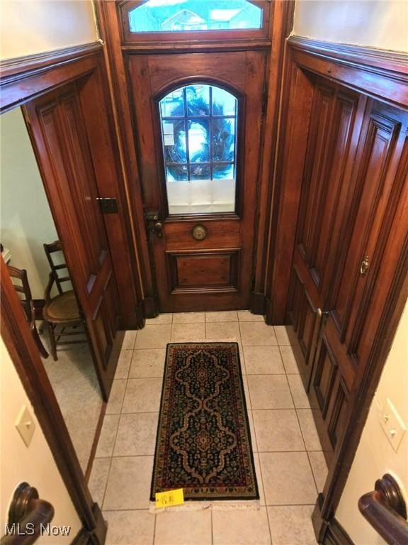 doorway featuring light tile patterned flooring