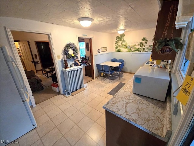 kitchen featuring white refrigerator and light tile patterned flooring