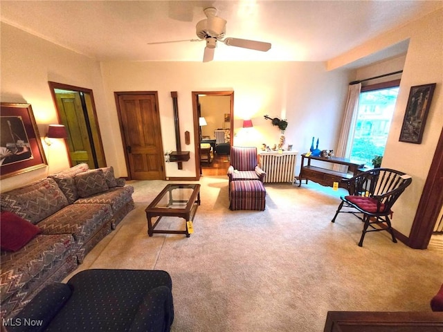 carpeted living room with ceiling fan