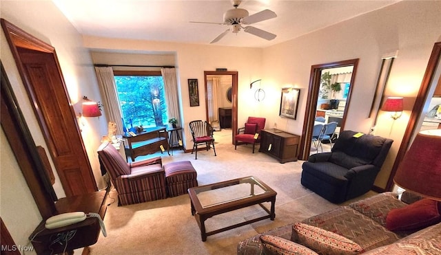 living room with ceiling fan and light colored carpet