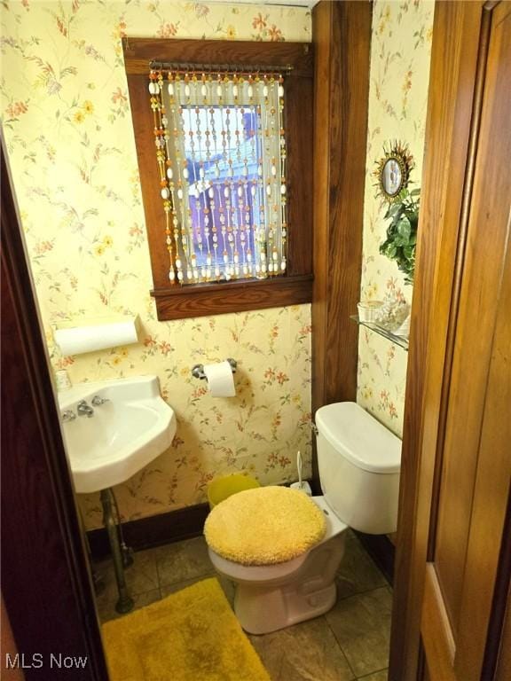 bathroom featuring sink, tile patterned floors, and toilet