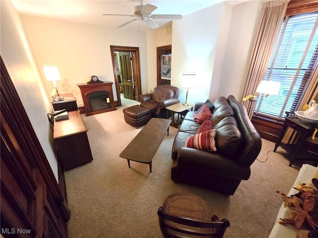 living room featuring a healthy amount of sunlight, carpet floors, and ceiling fan