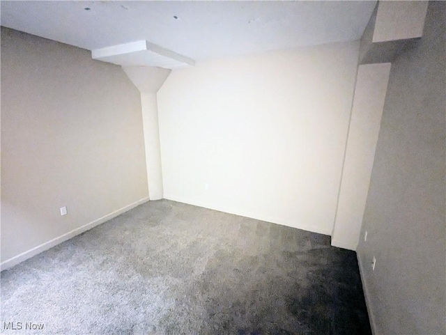 unfurnished room with dark colored carpet