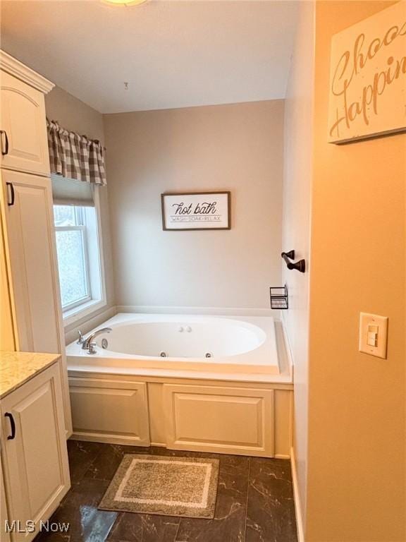 bathroom featuring vanity and a bath