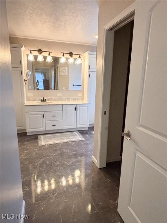 bathroom featuring vanity and a textured ceiling