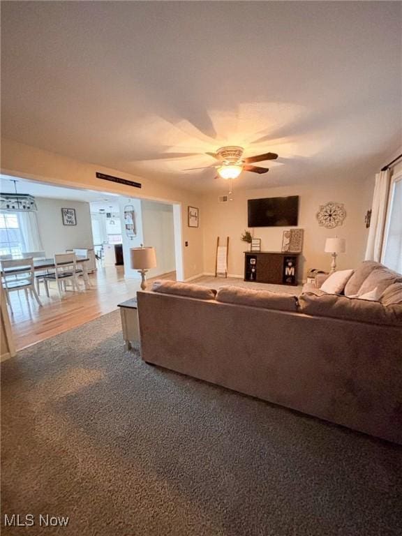 living room featuring ceiling fan and carpet flooring