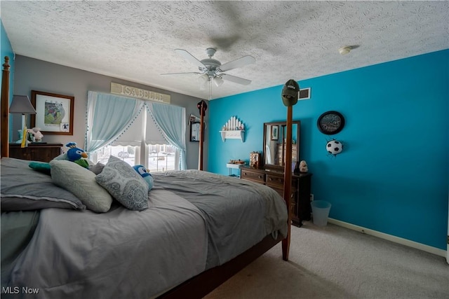 bedroom with carpet floors, a textured ceiling, and ceiling fan