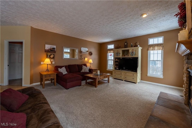 4615 Lexington Ridge Dr, Medina, OH 44256 - living room with a textured ceiling, a fireplace, baseboards, and carpet floors