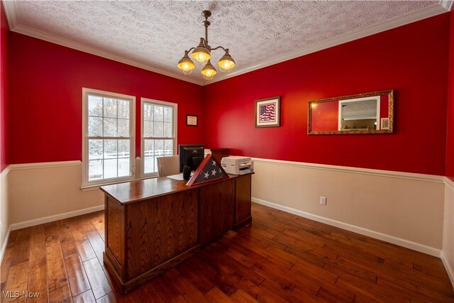 unfurnished office featuring an inviting chandelier, crown molding, dark hardwood / wood-style floors, and a textured ceiling