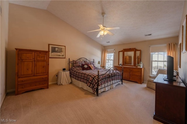 carpeted bedroom featuring ceiling fan, vaulted ceiling, multiple windows, and a textured ceiling