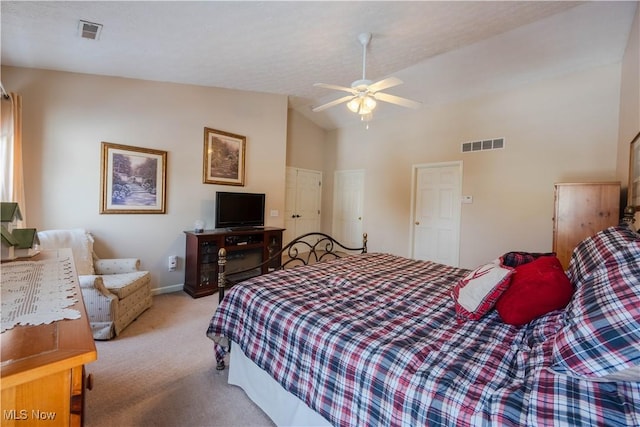 carpeted bedroom featuring ceiling fan and high vaulted ceiling