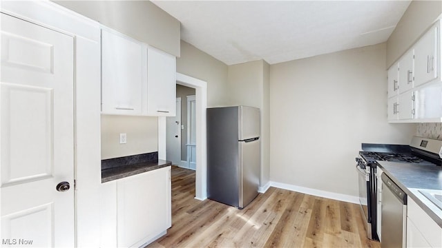 kitchen featuring stainless steel appliances, light hardwood / wood-style floors, and white cabinets