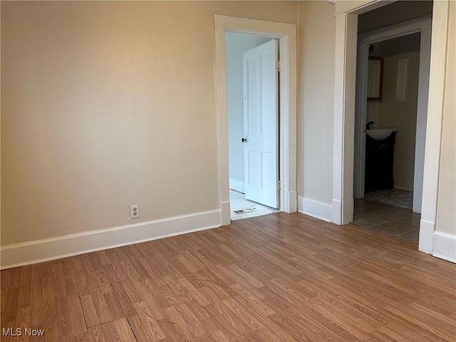 unfurnished room with hardwood / wood-style flooring