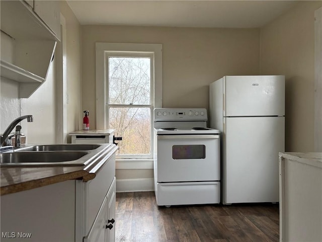 kitchen featuring dark wood-type flooring, white appliances, a healthy amount of sunlight, and white cabinets