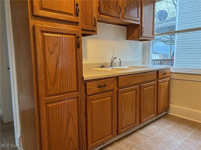 kitchen with sink and light tile patterned flooring