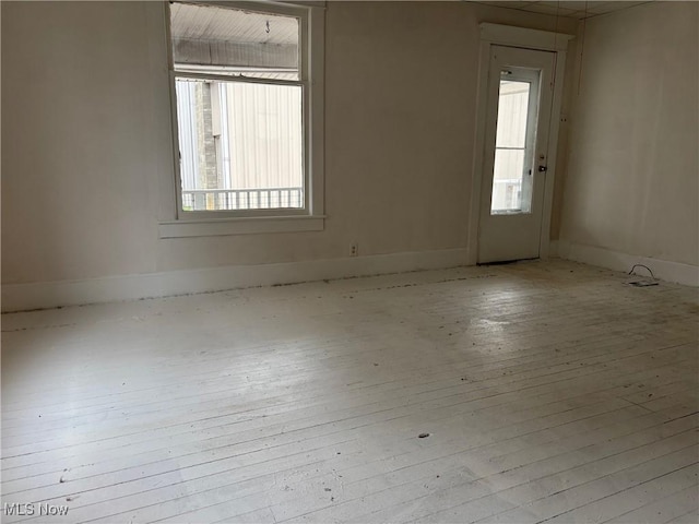 unfurnished room with light hardwood / wood-style floors