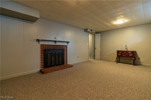 basement with a fireplace and carpet