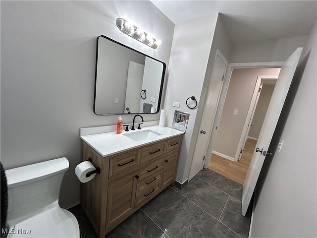 bathroom featuring vanity and toilet