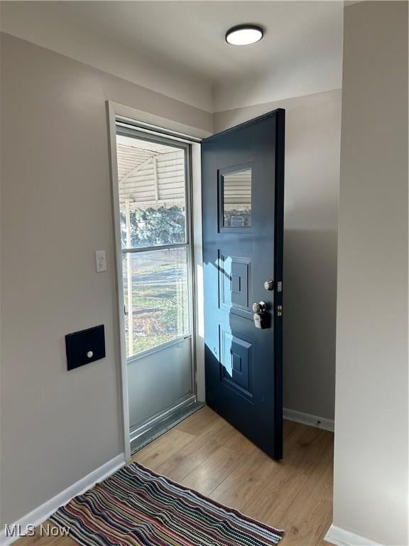 doorway with light wood-type flooring