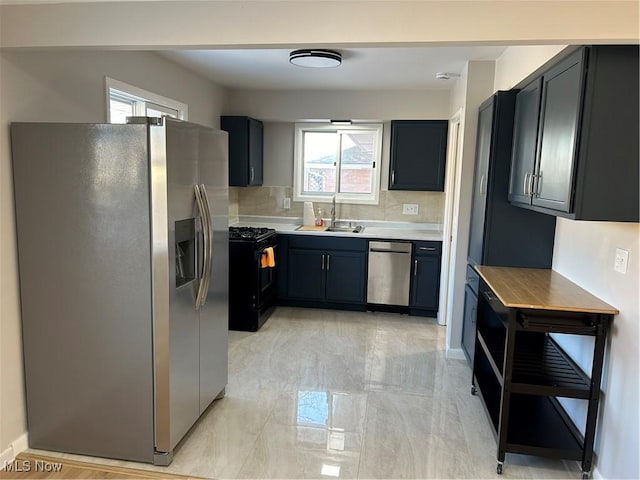 kitchen featuring tasteful backsplash, sink, and appliances with stainless steel finishes