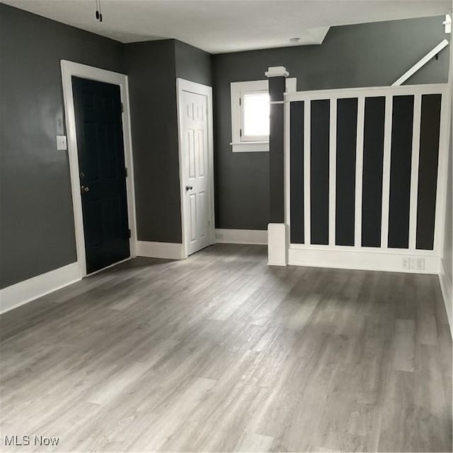 unfurnished room featuring hardwood / wood-style flooring