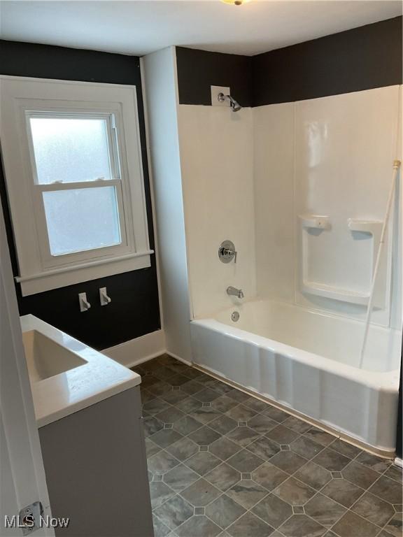 bathroom with vanity and bathing tub / shower combination