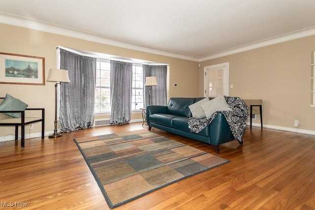 living room with wood-type flooring and crown molding