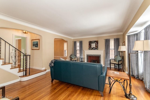 living room with hardwood / wood-style flooring and ornamental molding