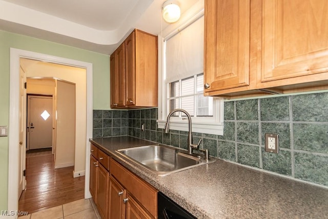 kitchen with sink, light tile patterned floors, and decorative backsplash