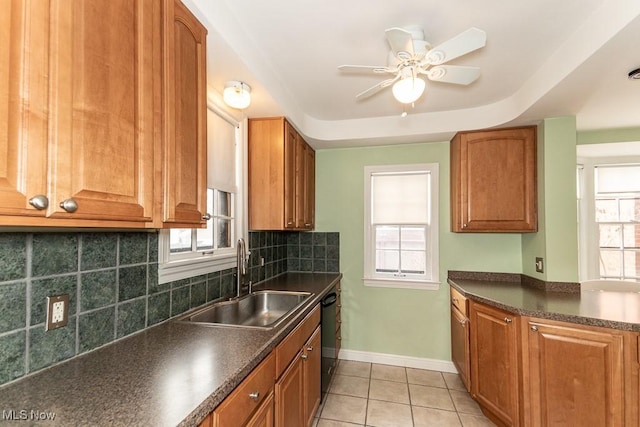 kitchen with dishwasher, sink, decorative backsplash, and a wealth of natural light