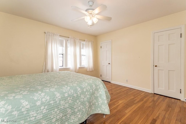 bedroom featuring wood-type flooring and ceiling fan