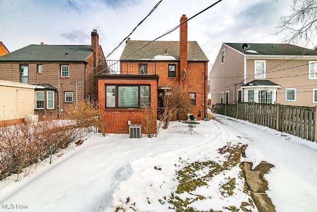 snow covered house with cooling unit