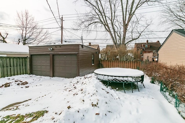 yard layered in snow with a garage