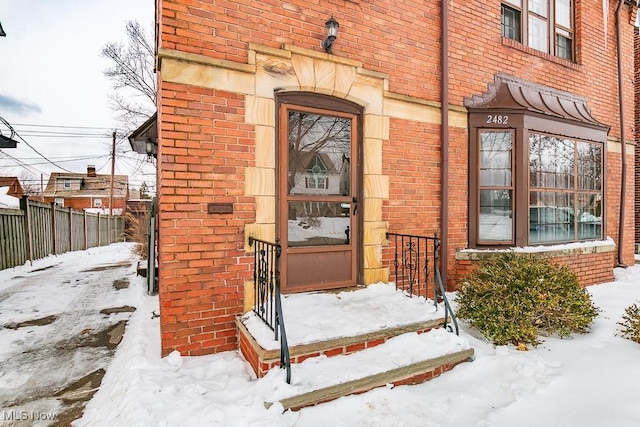 view of snow covered property entrance